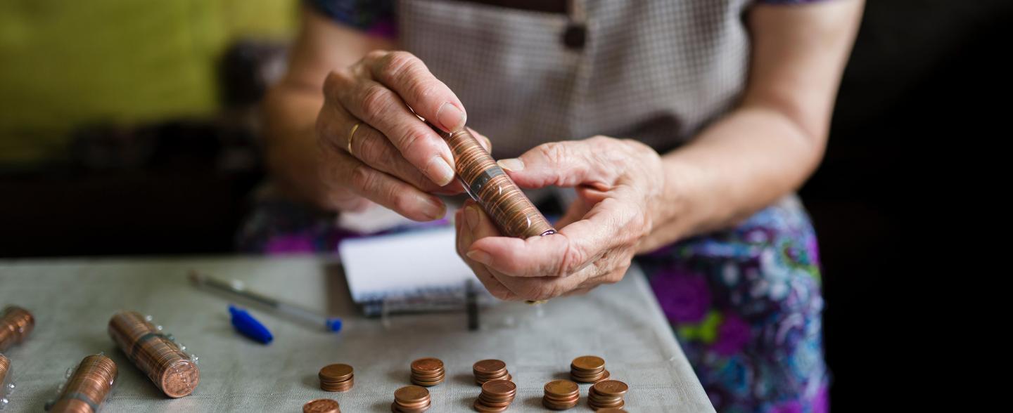 Elderly adult stacking pennies