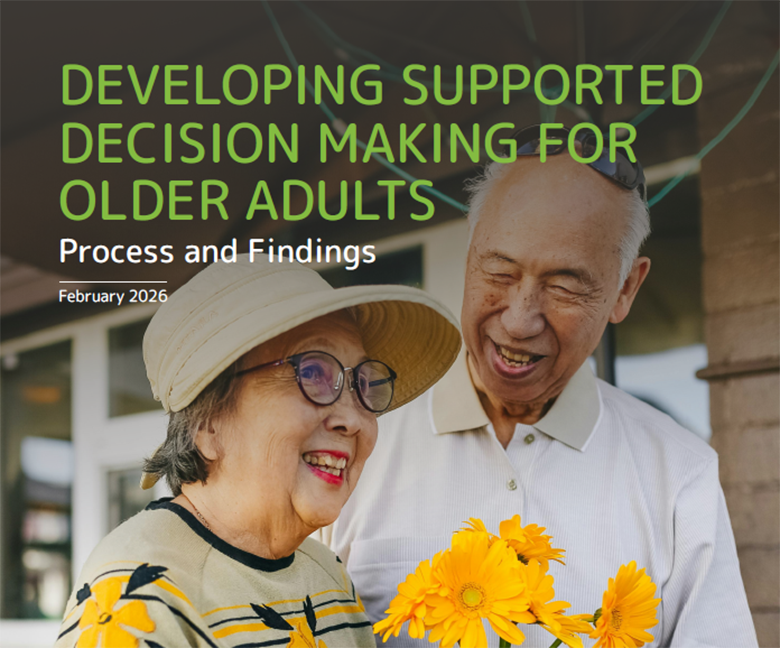 An older Asian couple smiling with a bouquet of flowers.