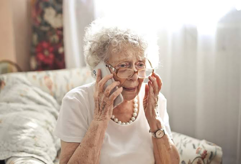 older woman with glasses on cellphone