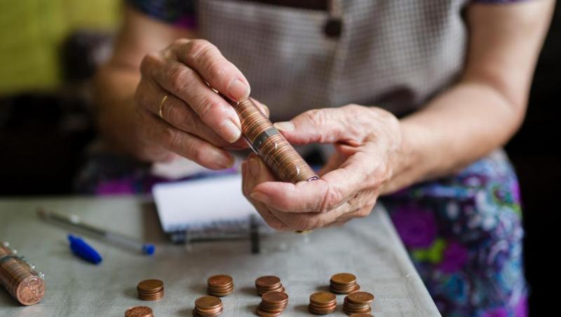 Elderly adult stacking pennies