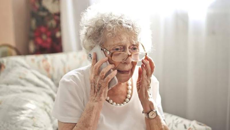 older woman with glasses on cellphone