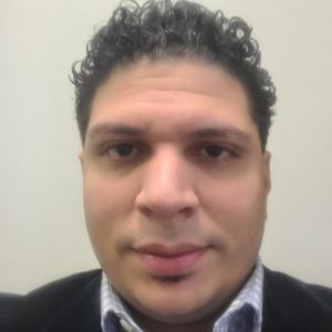 Close up of male face. He has curly hair.